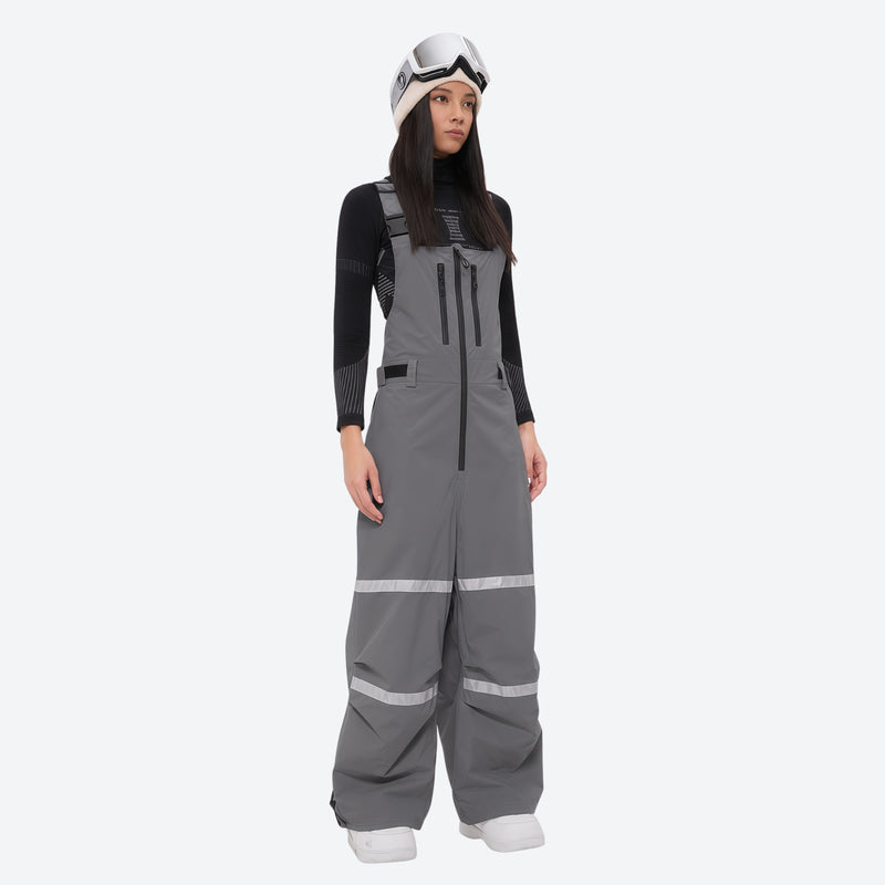 Women's reflective trim ski jacket with suspender bibs - gray bib pants, on-model front view, for resort and street wear