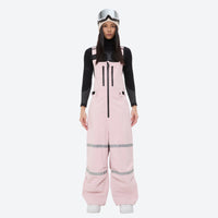 
                  
                    Unisex snowboard bib pants - pink bib pants with black top, on-model front view, for skiing and snowboarding
                  
                