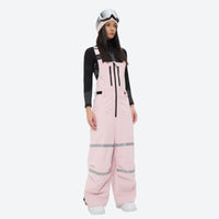 
                  
                    Unisex waterproof 3L bib snow pants - pink bib pants with black top, on-model front view, for resort and street wear
                  
                