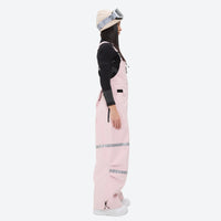 
                  
                    Breathable 3-layer suspender bibs with reflective trim - pink bib pants with black top, for powder days and winter commute
                  
                