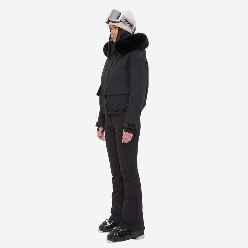 Women's waterproof 3L ski jacket and bib pants series - black fur trim hood jacket with black bib pants, on-model side view