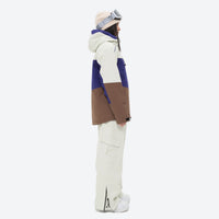 
                  
                    Women's waterproof 3L snow jacket and pants series - blue and brown colorblock jacket with white pants, on-model side view
                  
                