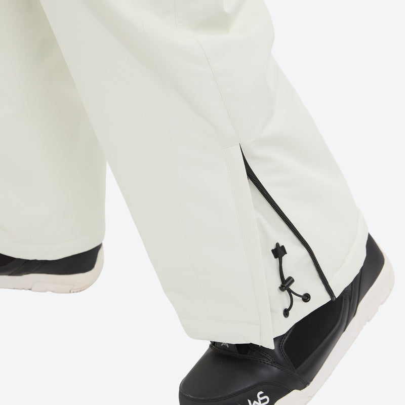 Breathable ski jacket with quilted lining - white snow pants, hem close-up over shoe detail, for resort and backcountry days