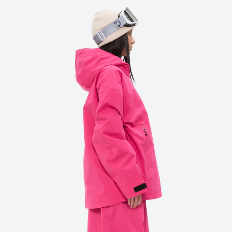 Women's 3-layer snowboard anorak and pants - rose pink, on-model side view, for resort and backcountry days