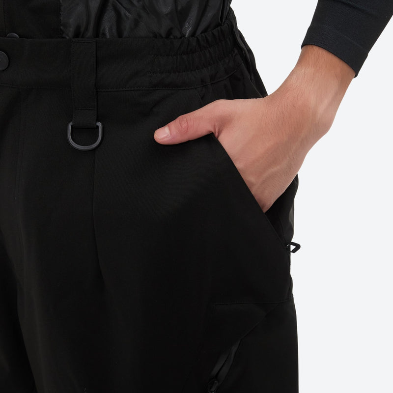 Men's breathable half-zip ski pullover set - black snow pants, waist pocket close-up with hand, for skiing and snowboarding