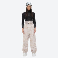 
                  
                    Unisex printed snowboard jacket and bibs - cream tan marble print bib pants, on-model front view, for skiing and snowboarding
                  
                