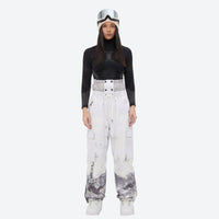 
                  
                    Women's waterproof 3L snow jacket and pants series - white mountain print snow pants with black top, on-model front view
                  
                