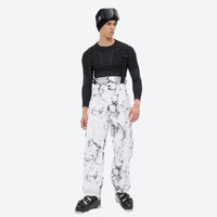 
                  
                    Unisex printed snowboard jacket and bibs - white marble print bib pants, on-model front view, for cold-weather winter sports
                  
                