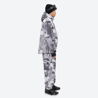 
                  
                    Unisex printed snowboard jacket and bibs - gray camo marble print suit, on-model side view, for powder and piste riding
                  
                