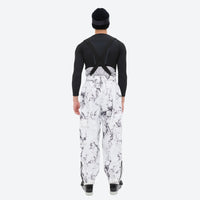 
                  
                    Unisex printed snowboard jacket and bibs - white marble print bib pants, on-model back view, for resort and backcountry days
                  
                