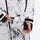 Unisex printed snowboard jacket and bibs - white marble print, cuff close-up with hand, adjustable detachable suspenders