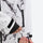 Unisex printed snowboard jacket and bibs - white marble print, cuff strap close-up with hand, for cold-weather winter sports