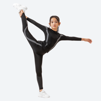 
                  
                    Kids' quick-dry baselayer suit for sports - black and pink kids compression base layer suit on girl, leg-raise pose view
                  
                