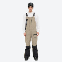 
                  
                    Men's waterproof 3L bib snow pants - tan bib snow pants with white top, full-body front view, for resort and backcountry days
                  
                