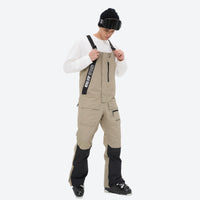 
                  
                    Men's breathable 3-layer suspender ski pants - tan bib snow pants with white top, for cold-weather winter sports
                  
                