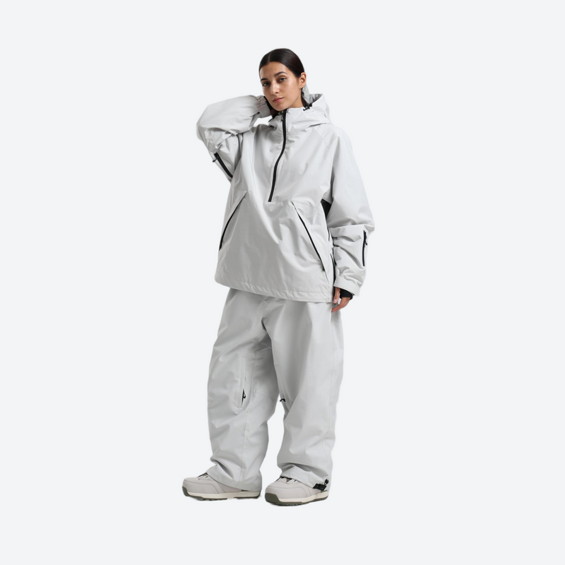 Women's waterproof 2L anorak snow jacket and pants - light gray anorak jacket with white pants, front view with hand on head
