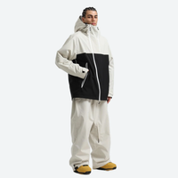
                  
                    Men's colorblock ski anorak set - cream and black colorblock, on-model three-quarter front view, knee vents dump heat
                  
                
