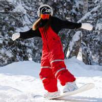 
                  
                    Unisex snowboard bib pants - red bib pants, riding snowboard on snowy slope, for powder days and winter commute
                  
                