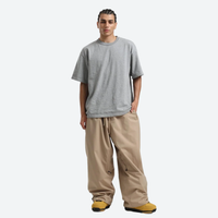 
                  
                    Men's breathable 2-layer snowboard jacket and pants - tan snow pants, on-model front view, for cold-weather winter sports
                  
                