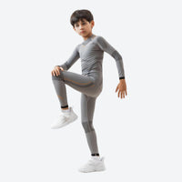 
                  
                    Kids compression base layer suit - gray kids compression base layer suit, leg-raise pose view, for kids sports and training
                  
                