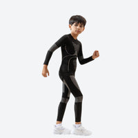 
                  
                    Kids quick-dry baselayer suit for sports - black olive kids compression base layer suit on boy, running pose view
                  
                
