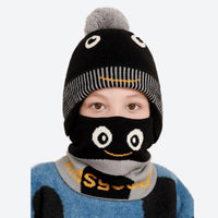
                  
                    Cosmo kids beanie and facemask set with cartoon print - black pom kids beanie with black monster facemask, worn front view
                  
                