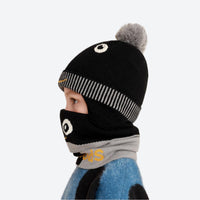 
                  
                    Knitted kids beanie facemask combo for snow days - black pom kids beanie with black monster facemask, worn side view
                  
                