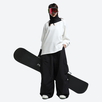 
                  
                    Men's adjustable snowboard cargo pants with gaiters - black cargo snow pants with white top, for powder and piste riding
                  
                