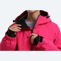 
                  
                    Women's waterproof 2L anorak snow jacket and pants - rose pink, collar close-up with hand, for powder days and winter commute
                  
                