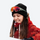 Warm wool knit beanie for winter sports - black wool snow beanie on women with goggles and red jacket, worn front view
