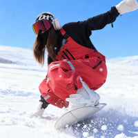 
                  
                    Unisex waterproof 3L bib snow pants - red bib pants, carving turn on snowy slope, for cold-weather winter sports
                  
                