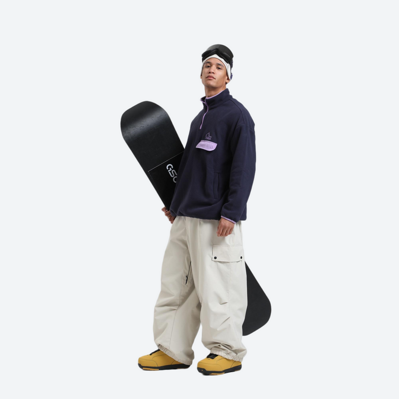 3-layer snowboard cargo pants - cream snow pants, on-model front holding snowboard horizontal, for cold-weather winter sports