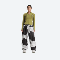 
                  
                    Women's 2-layer snowboard jacket and pants - olive green base layer top with cow print snow pants, on-model front view
                  
                