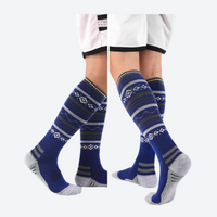 
                  
                    Breathable knee-high merino ski socks with jacquard - navy patterned merino ski socks on feet, for winter snow sports
                  
                