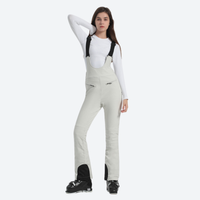 
                  
                    Women's slim fit waterproof ski bib pants - cream slim fit ski bib, front view with hand at head, for skiing and snowboarding
                  
                