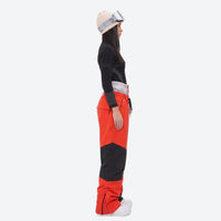 
                  
                    Waterproof snow jacket and pants set - women's orange colorblock pants with black base layer, for powder and piste riding
                  
                