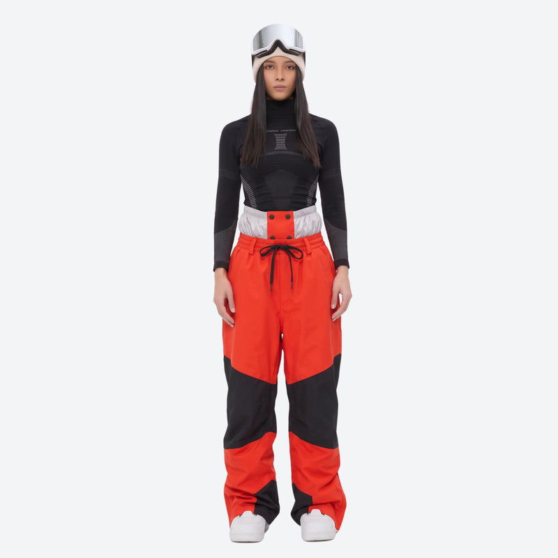 Colorblock snowboard jacket and pants set - women's orange colorblock pants with black base layer, on-model front view