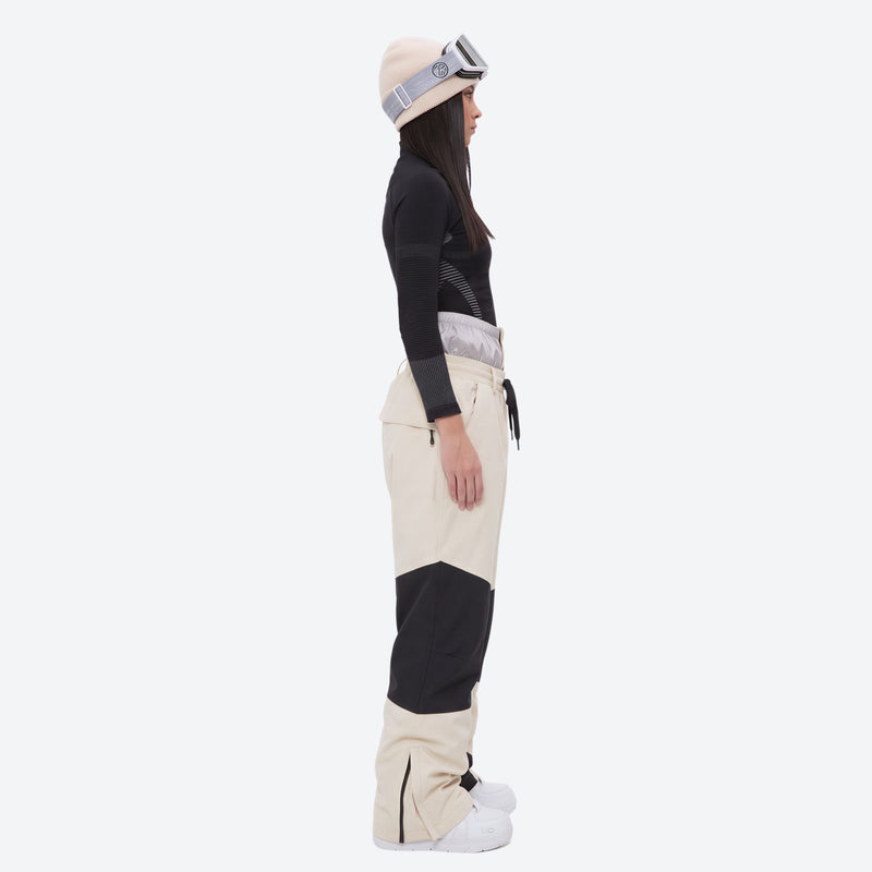 Colorblock snowboard jacket and pants set - women's cream colorblock pants with black base layer, on-model side view