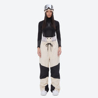 
                  
                    Breathable ski jacket and snow pants combo - women's cream colorblock pants with black base layer, on-model front view
                  
                
