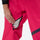 Women's snowboard jacket and wide-leg pants - pink snow pants, thigh zip vent close-up with hand, for skiing and snowboarding