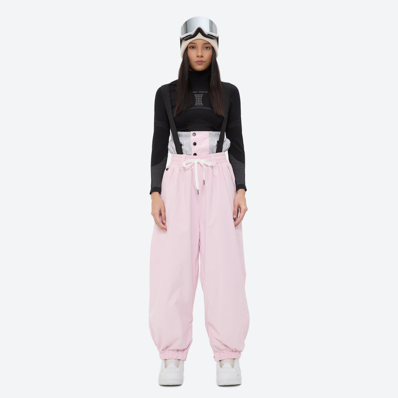 Women's quilted lining ski jacket with suspender bibs - light pink bib pants with black top, on-model front view