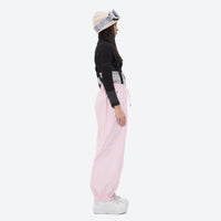 
                  
                    Women's 2-layer snowboard jacket and bibs - light pink bib pants with black top, for powder days and winter commute
                  
                