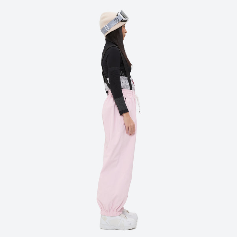 Women's 2-layer snowboard jacket and bibs - light pink bib pants with black top, for powder days and winter commute