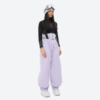 
                  
                    Women's quilted lining ski jacket with suspender bibs - lavender bib pants with black top, for skiing and snowboarding
                  
                