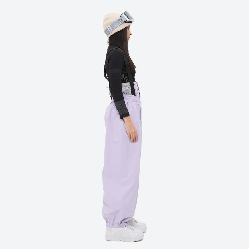 Women's 2-layer snowboard jacket and bibs - lavender bib pants with black top, on-model side view, for resort and street wear