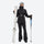 Women's belted snow jacket with suspender pants - black, front with upright skis and poles, for resort and cross-country days