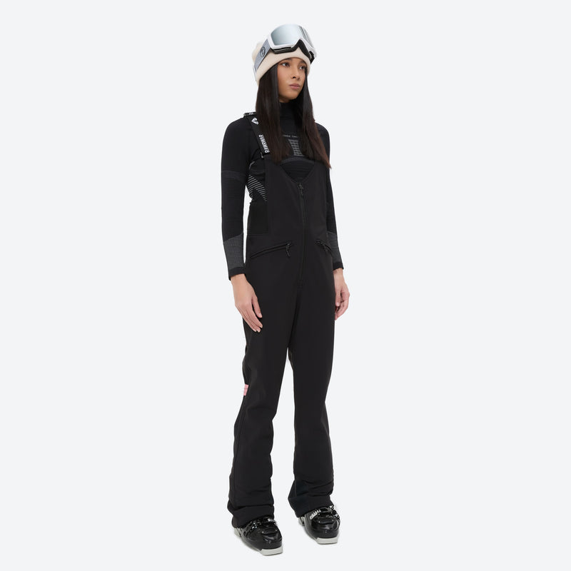 Women's fur trim hood snow jacket with suspender bibs - black bib pants, on-model front view, for cold-weather winter sports