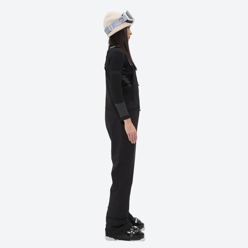 Women's 3-layer breathable ski suit set - black bib pants, on-model side view, for snowy mountain travel