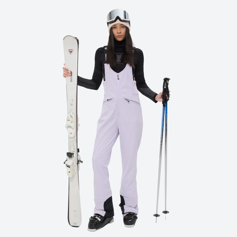 Women's 3-layer breathable ski suit set - lavender bib pants, front with upright skis and poles, for snowy mountain travel