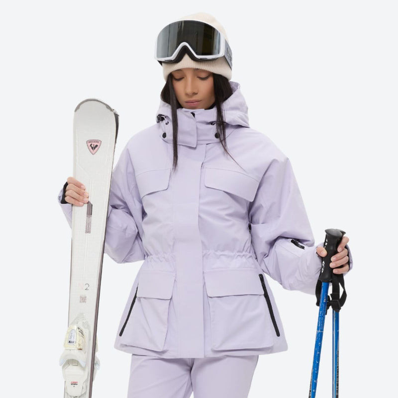 Women's 3-layer breathable ski suit set - lavender, front with upright skis and poles, for resort and cross-country days